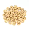 Close-up detail of golden flower metal spacer beads, perfect for DIY handmade jewelry crafts. - 10 Pieces / Gold / 4mm