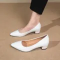 Detail shot of elegant white pointed toe block heel pumps showcasing clean design and fit. - 35 / White