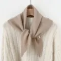 Detailed view of a cozy wool blend knitted triangular scarf in neutral khaki, soft texture. - Khaki