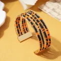 Bohemian multi-layer manchet armband met opvallende zwarte en oranje kraaltjes. - Tweekleurig 14 / Goud