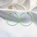 Lichtgroene metalen creolen detailfoto met glanzende afwerking en glad rond ontwerp. - Mosterdgroen