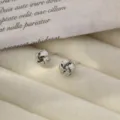 Silver metal knot stud earrings, geometric design, elegant minimalist everyday jewelry style. - Spiral Earrings Style O - White Gold