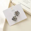Detail view of sparkling crystal flower hair claw clips with elegant dark rhinestones. - Marquise Rhinestone Flower Black Gray