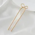 Minimalist gold metal U-shaped hairpin with cute bow detail, perfect for elegant hair styling. - Bow Tie