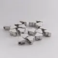 Detailed view of shiny silver heart spacer beads, ideal for custom DIY charm bracelet making. - Silver Heart-Shaped Hole Beads / 200 Pieces/Pack