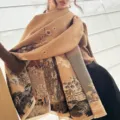 Detail view of the Chinese style cashmere scarf showing traditional landscape and plum blossom prints. - Brown