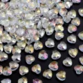 Close-up detail of iridescent crystal heart beads with faceted cut for DIY jewelry making. - AB White