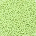 Close-up detail of light green glass drop seed beads, ideal for DIY jewelry making crafts. - 20g/Pack / Fruit Green