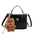Black PU leather top-handle lock box bag with cute brown plush dog charm, stylish crossbody. - Single Bag / Black