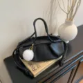 Black leather shoulder bag for women, chic soft handbag with knot detail and white charm. - With Pendant / Black