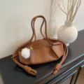 Brown leather shoulder bag with knotted strap and fluffy pompom charm for women. - With Pendant / Brown