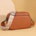 Stylish brown pebbled leather crossbody bag with wide geometric strap for women daily use. - Brown