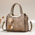 Brown multi-layer handbag with metal top handle, floral charm and adjustable strap. - Length 24 Width 12 Height 19 Handle 12cm / Khaki