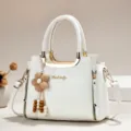 White PU leather handbag detail, featuring gold metallic handles and cute beaded flower pendant. - Length 24 Width 12 Height 19 Handle 12cm / White