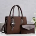 Dunkelbraune Ledertasche Detail mit strukturierter Oberfläche und Herz-Schlüssel-Anhänger. - Kaffeebraun