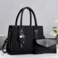 Black commuter women handbag set with shoulder strap and key charm detail view. - Black