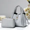 Grey handbag set detail view, casual tote and crossbody bag with gold tone hardware. - Gray
