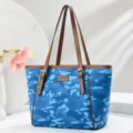 Blue camouflage tote bag detail showing brown leather handles and chic fashion front patch. - L 29 W 15 H 27 Handle 25cm / Aquamarine