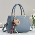 Blue-grey women's handbag with top handle, chic shoulder strap and cute bear plush charm. - Blue