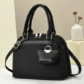 Elegant black shoulder crossbody bag with unique pleated texture, gold hardware and mini pouch. - L 29 W 13 H 21 Handle 14 cm / Black