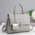 Chic grey leather women's shoulder crossbody bag featuring a miniature charm pendant detail. - Gray