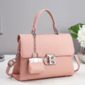 Pink leather handbag for women with top handle, metal lock clasp and cute mini bag charm. - 25x10x18cm / Pink