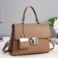 Chic brown leather top handle handbag featuring stylish metal hardware and a mini bag charm. - 25x10x18cm / Khaki