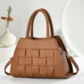 Vue détaillée du sac à main en cuir tissé marron, mettant en valeur un savoir-faire exquis. - Jaune Terre