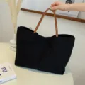 Casual black canvas tote bag with brown leather handles, large capacity daily shoulder handbag. - Black