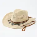 Nahaufnahme des gewebten Stroh-Cowboyhuts mit Perlen-Boho-Anhänger und Kinnriemen. - Erwachsene 57cm / Beige