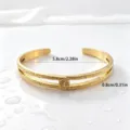 Detailed view of the gold-plated stainless steel Hawaiian vine cuff bracelet close-up. - Double Layer Cutout Style (XYB0187) / Gold