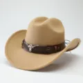 Close-up detail of western cowboy hat with bull skull emblem and brown leather hat band. - 56-58cm / Camel