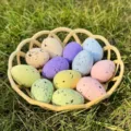 Close-up detail of colorful speckled Easter eggs in a yellow basket on green grass decor. - Medium (3x4cm) / 12 Pieces/Pack (With Basket)