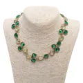 Detailed view of the luxury rhinestone crystal necklace, featuring vibrant green and yellow stones. - Necklace / Green