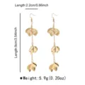 Detail view of long gold metal leaf tassel earrings showcasing exquisite craftsmanship and dimensions. - Gold Earrings