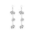 Close-up detail shot of long silver metal flower petal dangling earrings with delicate chain links. - Silver Earrings
