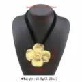 Statement large gold flower pendant necklace with multi-layer black cord detailed view. - Black Cord Gold