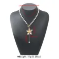 Detailed view of the sweet cool style frangipani pendant necklace with pearl chain and OT clasp. - Gold