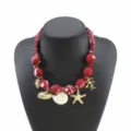Red fabric beaded necklace featuring gold starfish and seashell pendants, stylish vintage ocean choker. - Burgundy