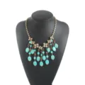 Turquoise beaded tassel statement necklace with gold claw chain and rhinestones detail. - Tassel Necklace / Blue