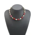 Close-up detail view of irregular red and gold beaded necklace, showing unique craftsmanship. - Necklace / Red