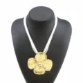Elegant multi-layer cord necklace featuring a statement large textured gold flower pendant for women. - White Cord Gold