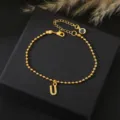 Goudkleurige kralenketting armband met letter U hanger en verstelbare verlengketting voor dames. - Letter U