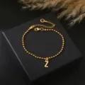Goudkleurige kraaltjes ketting armband met een beginletter Z hanger en handige verlengketting. - Letter Z