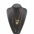 Collar largo de ante bohemio con colgantes dorados de sol y luna, joyería boho. - Café