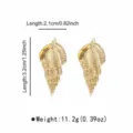 Detail view of the elegant golden conch shell earrings, showing exquisite texture. - Conch (E14721) / Gold