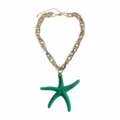 Detail view of the green resin starfish pendant on chunky gold chain, beach vacation style. - Green