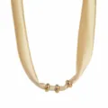 Close-up of the golden fabric silk scarf necklace showing metallic ring details and texture. - Gold Yellow