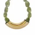 Closeup detail of green resin bead necklace with a statement gold tone curved metal tube. - Green