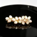 Elegant gold-tone rhinestone floral hair clip with white cat-eye stone petals, detail view. - Style 4 Large Five-Petal Flower